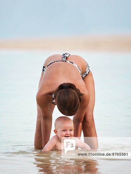Mother with baby bathing in sea  Thailand