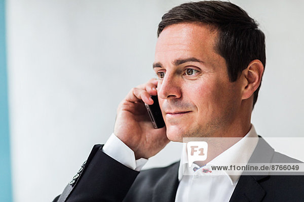 Mid adult businessman using cell phone  Stockholm  Sweden