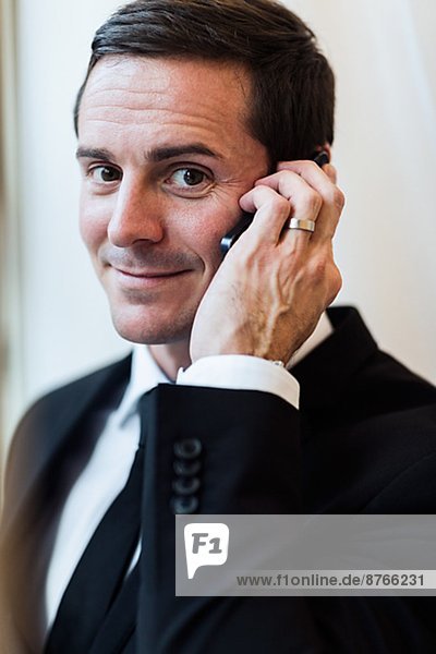 Mid adult businessman talking via cell phone  Stockholm  Sweden