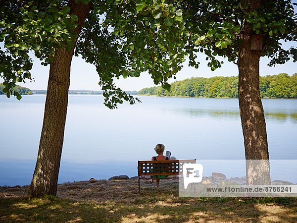 Woman sitting on bench  Skane  Sweden