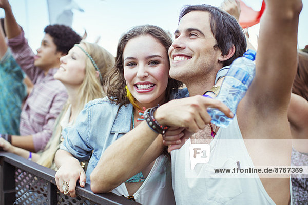 Couple cheering at music festival