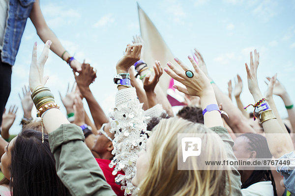 Fans reaching to shake hands with performer at music festival