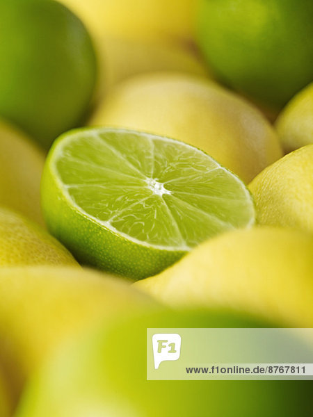 Extreme close up of sliced lime among lemons