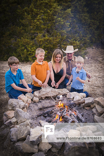 USA  Texas  Family Roasting marshmallows over camp fire