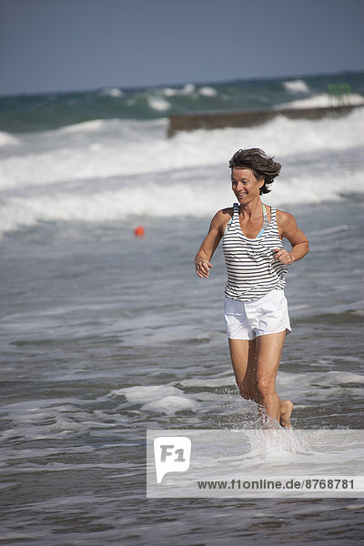 Greece  Crete  Mature woman running in water