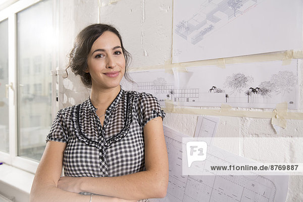 Portrait of young female architect in office