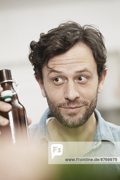 Man holding bottle of beer