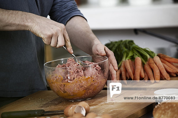 Man preparing dish in kitchen