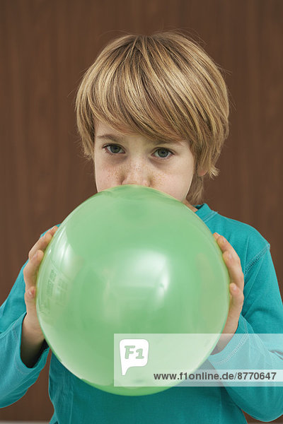 Germany  Boy inflatiing balloon
