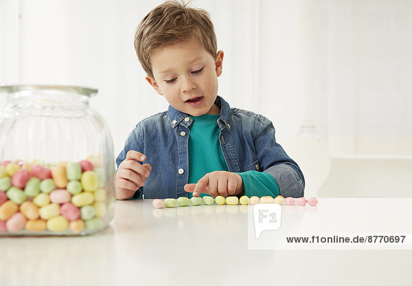 Boy with candy jar  counting candies