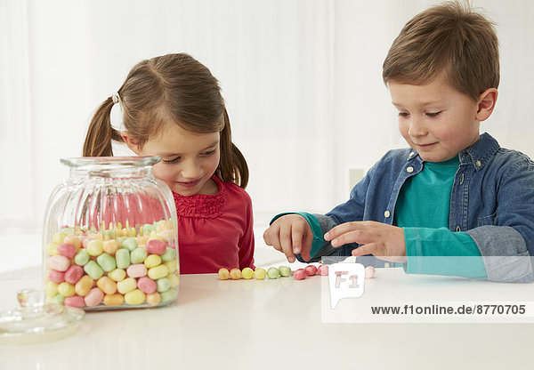 Boy and girl with candy jar