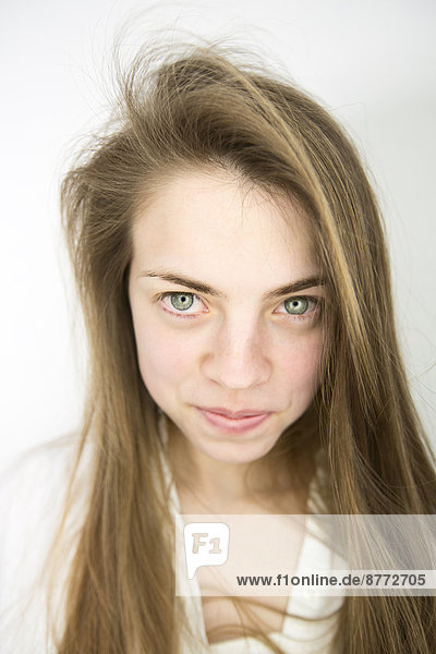 Portrait of smiling teenage girl with green eyes