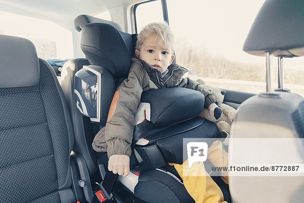 Germany  Little boy sitting in back-seat car seat