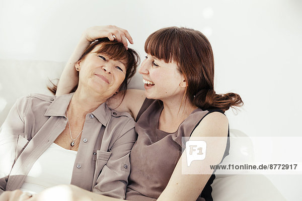 Portrait of mother and daughter laughing together