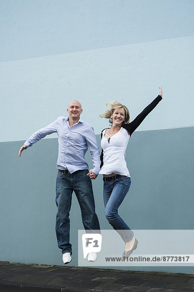 Young couple jumping in the air