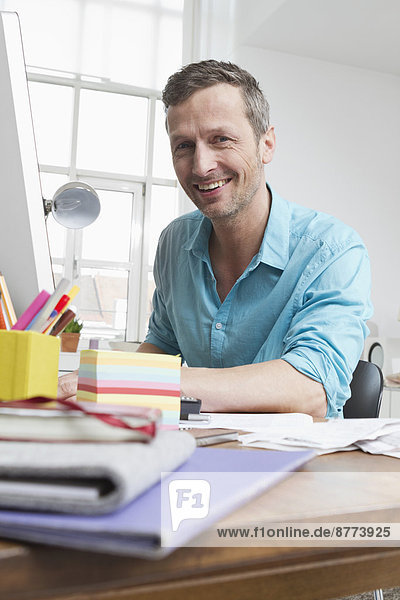 Portrait of smiling man at desk