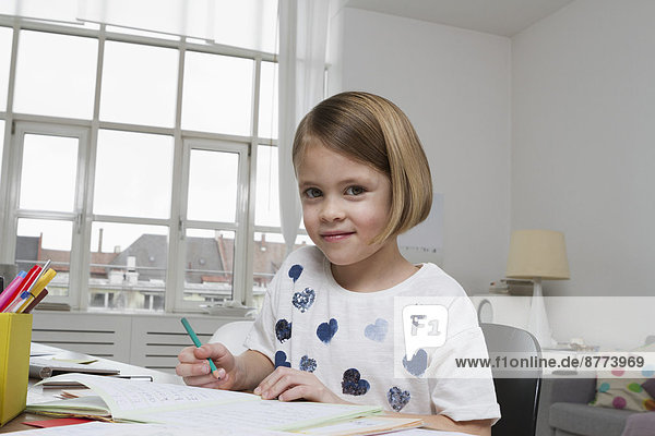 Portrait of girl at desk drawing