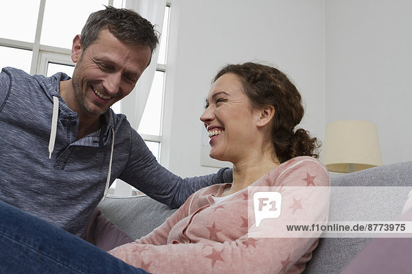 Happy couple sitting on couch