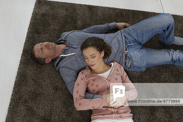 Couple sleeping on the floor