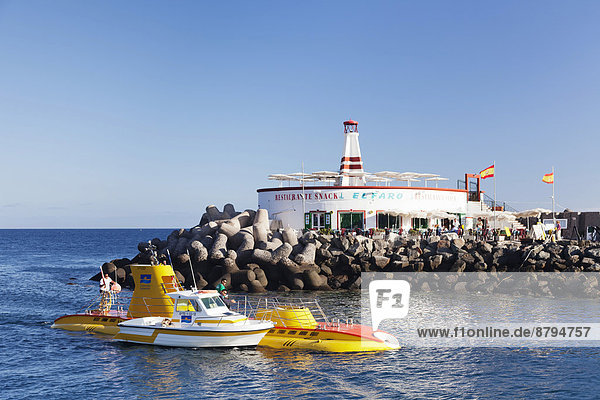 Submarine Yellow Submarine in front of lighthouse  Puerto de Mogán  Gran Canaria  Canary Islands  Spain