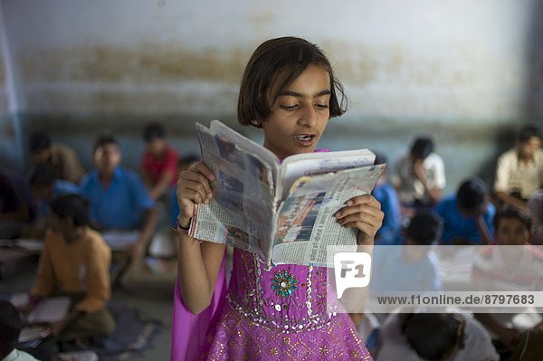 Indian girl reading aloud during English lesson at Rajyakaiya School in Narlai village  Rajasthan  Northern India