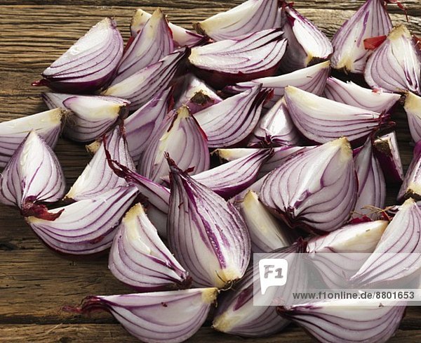 Quartered onions on a wooden surface