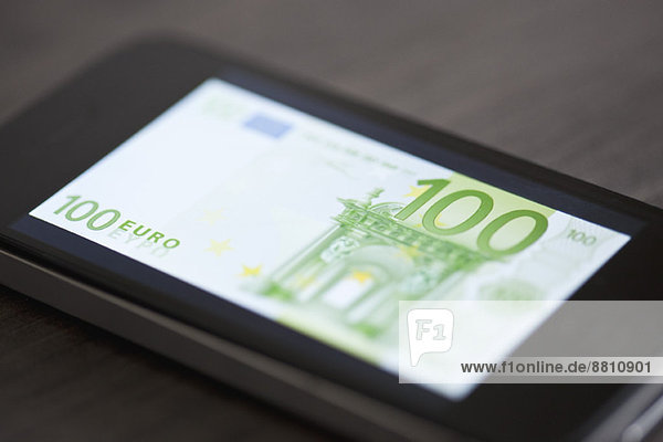 Smartphone displaying image of one-hundred euro banknote