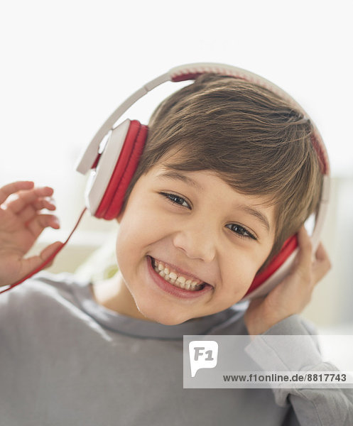 Hispanic boy listening to headphones