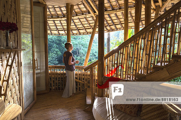Caucasian woman standing in bamboo room  Ubud  Bali  Indonesia