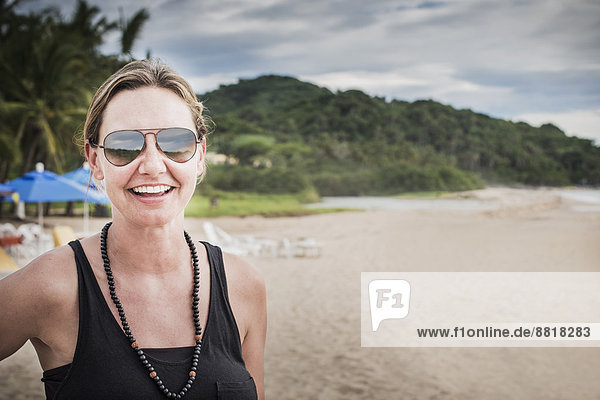 Caucasian woman smiling on beach