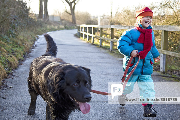 Girl going walkies with a labrador
