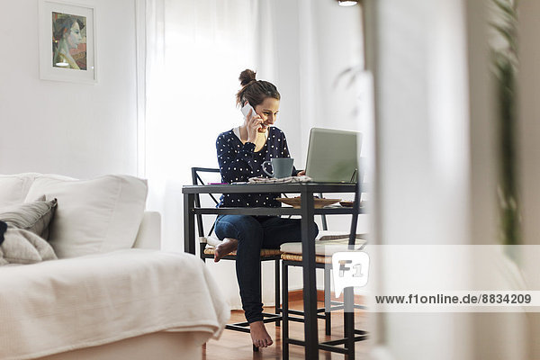 Young woman working with laptop at home