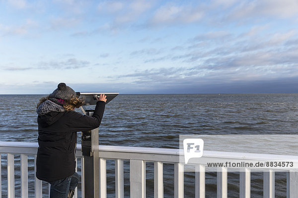 Germany  Cuxhaven  Tourist looking through binoculars