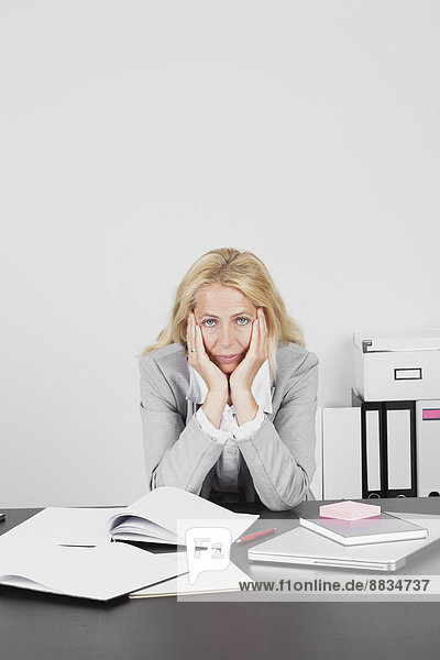 Frustrated businesswoman at desk