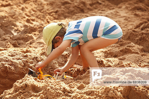 Kleiner Junge spielt im Sandkasten