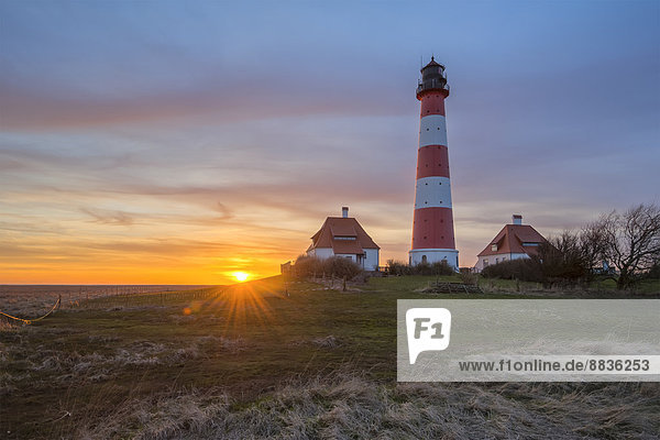 Germany  Schleswig-Holstein  North Sea Coast  View of Westerheversand Lighthouse at sunset