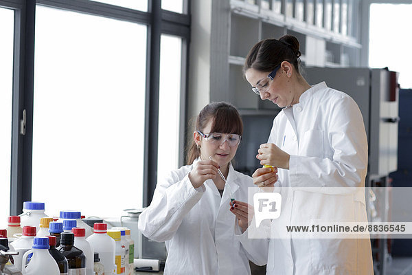 Two young female chemistry students in lab