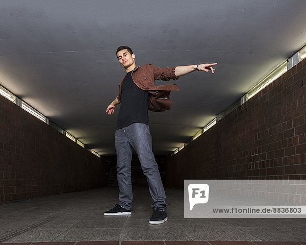 Young breakdancer in underpass