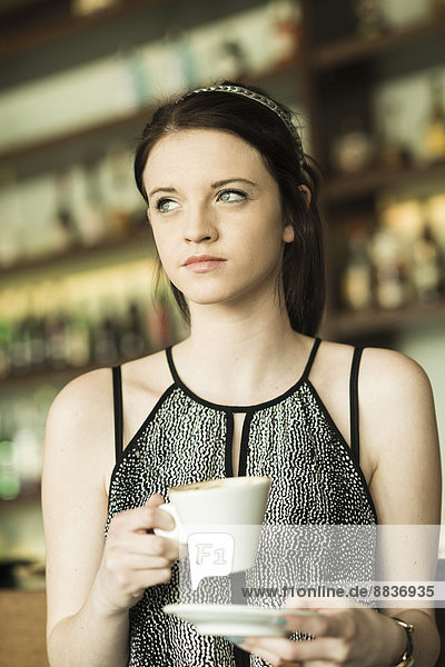 Portrait of young woman at cafe