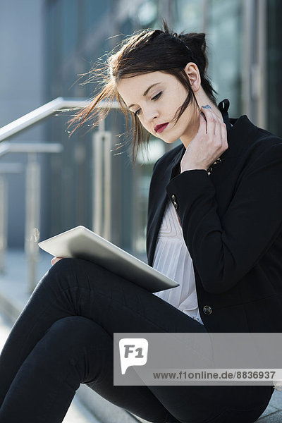 Portrait of young business woman using tablet computer