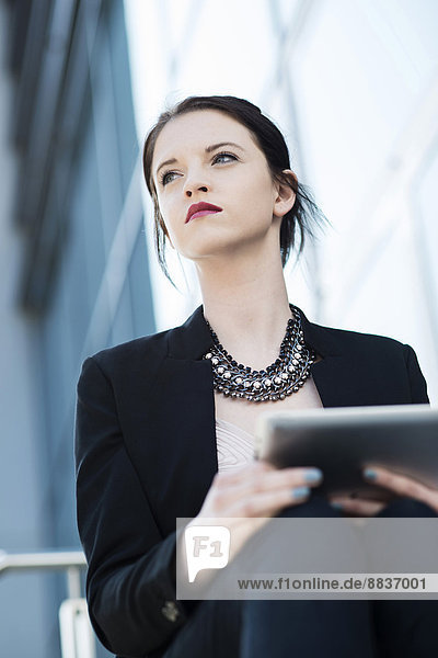 Portrait of young business woman with tablet computer