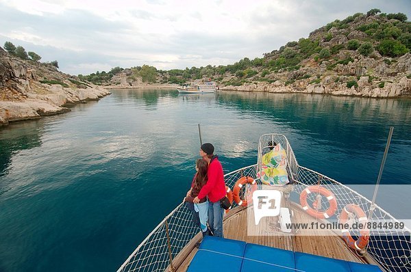 Tourists on the walking yacht look at ruins of the sunk city Kekova  Turkey.