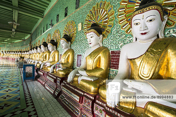 Many seated Buddha sculptures  walls decorated with glass mosaics  Umin Thounzeh  Umin Thonse or U Min Thonze Pagoda or 30 Caves Pagoda  Sagaing Hills near Mandalay  Myanmar