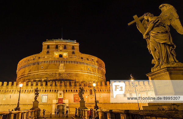 Castel Sant'Angelo  Mausoleo di Adriano or the Mausoleum of Emperor Hadrian  and Ponte Sant'Angelo with angel statues by Bernini  at night  Rome  Lazio  Italy