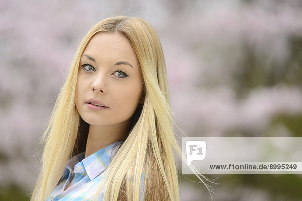 Young blond woman in a park in spring