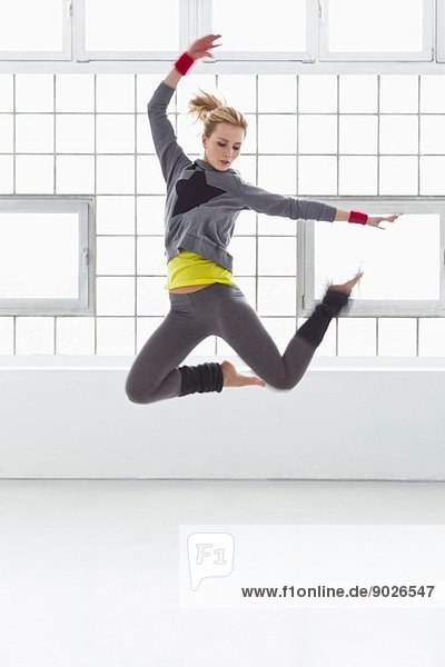 Young woman jumping in gymnasium