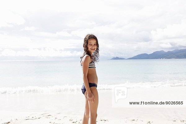 Girl standing on beach in Seychelles