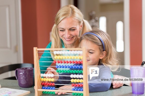 Mother and young daughter with abacus