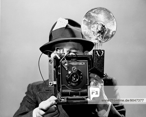 Newspaper photographer with flashbulb camera