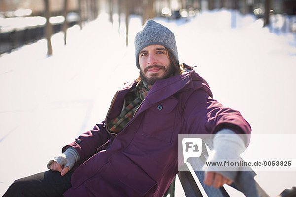 Smiling mid adult man sitting on bench  New Jersey  USA